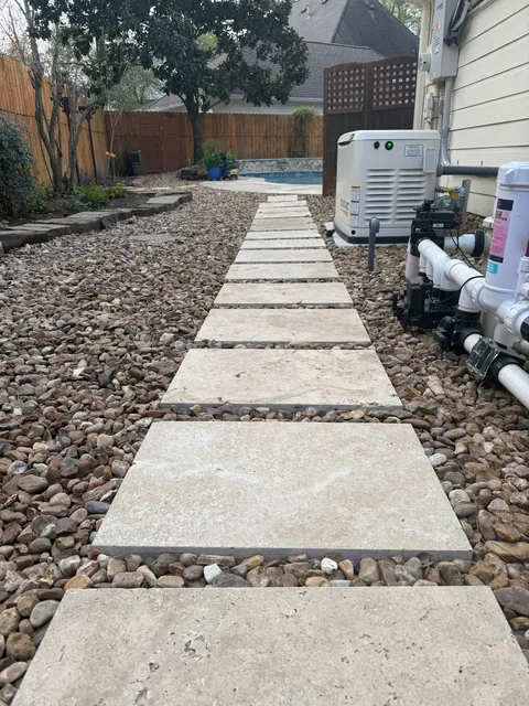 Stone paver walkway through a landscaped gravel bed